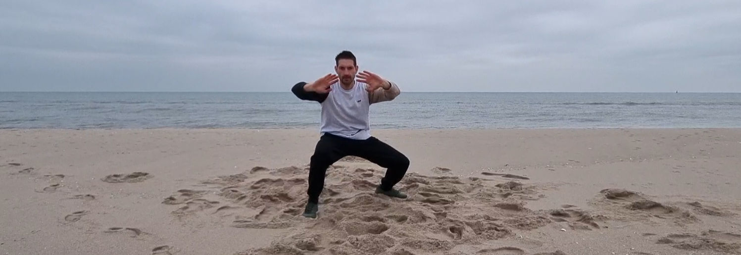Wouter Mets oefent een vloeiende beweging op het strand